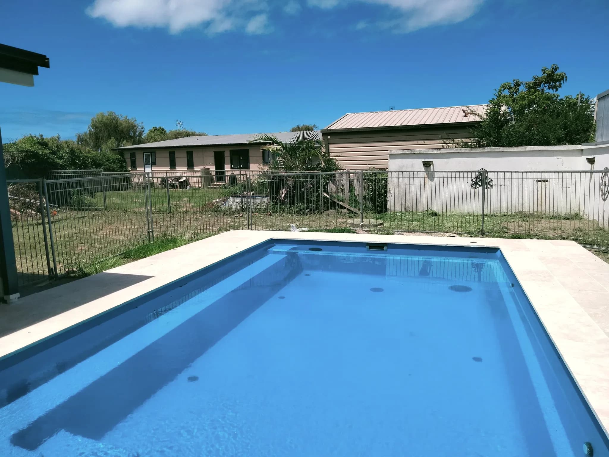 Greenwell — The pool with the rear of the dwelling behind