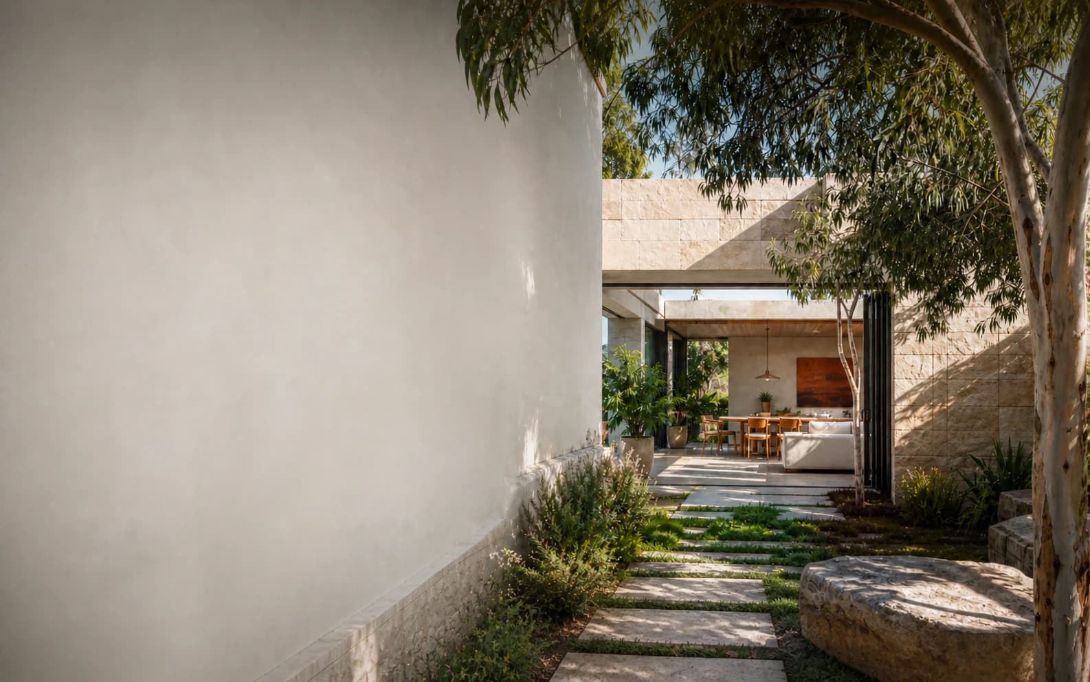 Concept visualisation — a modern rendered home with a sandstone courtyard under gum trees